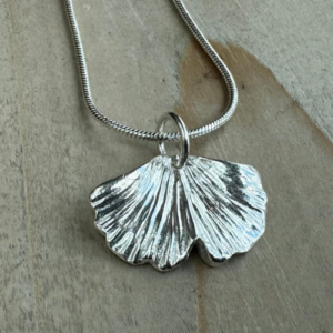 silver necklace with gingko shaped leaf pendant