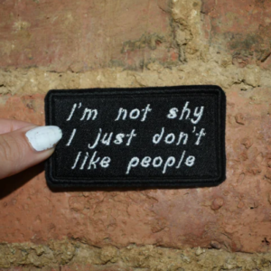 black iron on patch with white writing saying I'm not shy I just don't like people