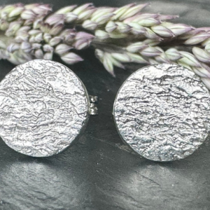 Small round silver stud earring with ripple textured finish